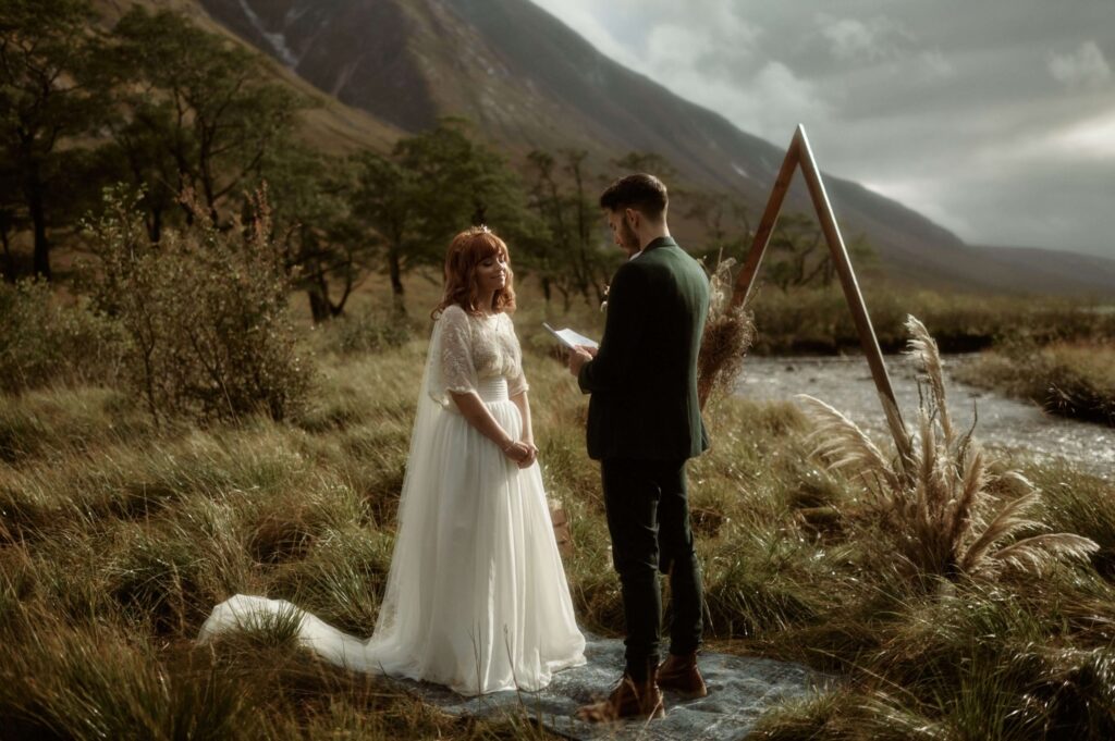 Bride and groom at their outdoor wedding in Scotland with stunning rugged landscape